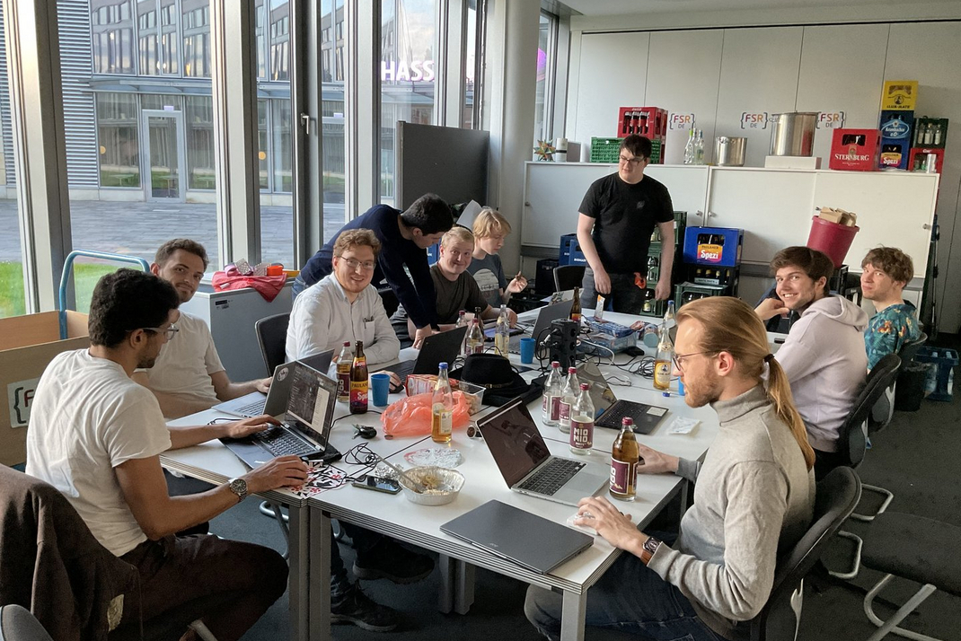 Members of the Casual Coding Club sit at a table and work