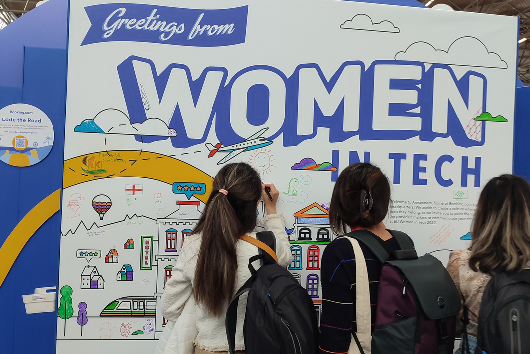 Three participants of the International Day of Women in Science 2023 paint on a poster