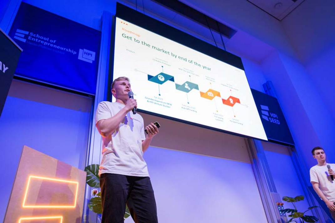 A participating startup team is presenting its roadmap on stage.