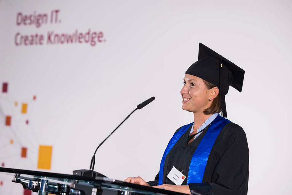 Caterina Mandel speaks at the HPI graduation ceremony 2022, wearing a gown and mortarboard.