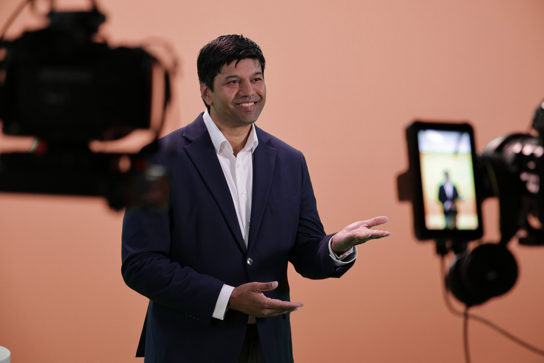 Prof. Gerard de Melo gives an interview in front of a camera crew.