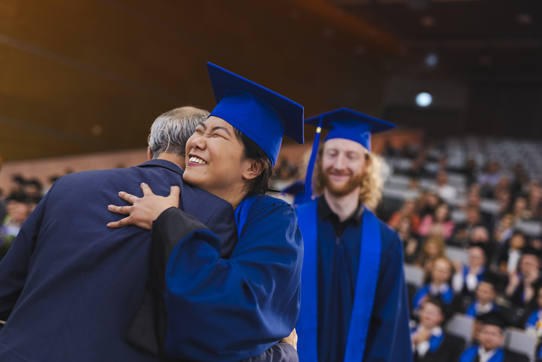 Graduates are hugging their professors and relatives
