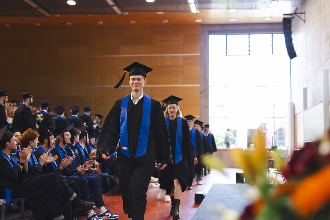 Graduates entering the stage together