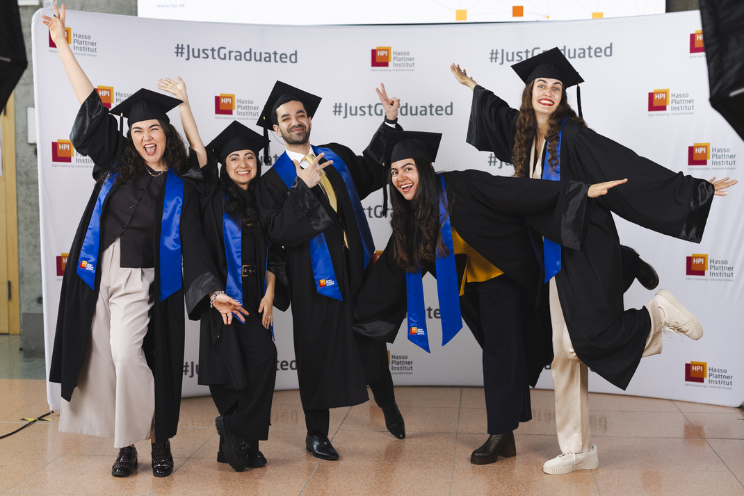 The photo shows graduates posing for their group photo