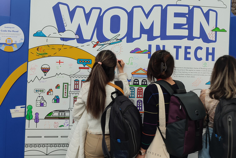 Three participants of the International Day of Women in Science 2023 paint on a poster