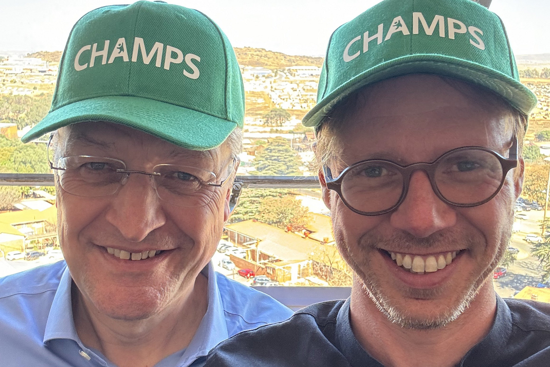  Prof. Lothar H. Wieler and Prof. Christoph Lippert wearing hats from CHAMPS (Child Health and Mortality Prevention Surveillance)